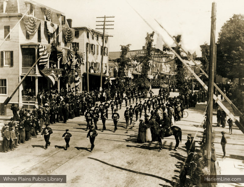 Admiral Dot leads the Fireman's Parade along Railroad Avenue, crossing the Harlem's tracks at grade